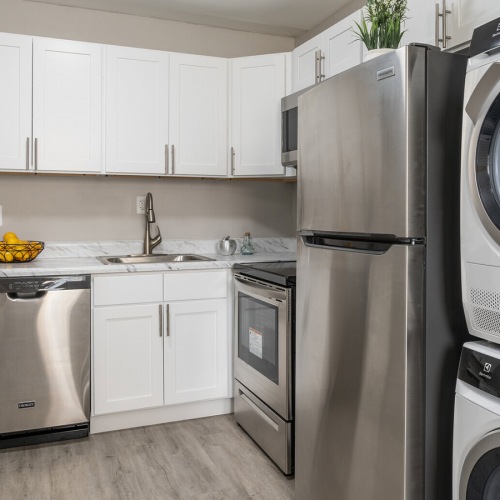 Kitchen Spacious and well lit kitchen with wood floors and stainless steel appliances