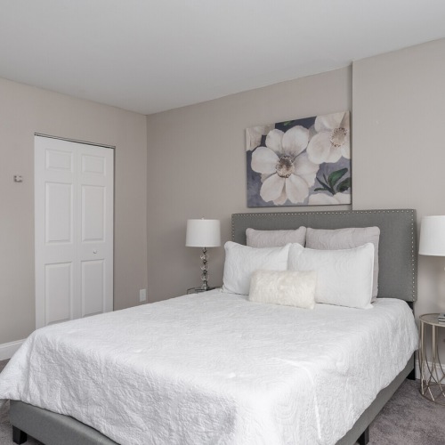 Bedroom Large bedroom with wood floors and a large window