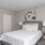 Large bedroom with wood floors and a large window